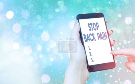 Text sign showing Stop Back Pain. Conceptual photo put an end on the pain felt in the low or upper back Modern gadgets with white display screen under colorful bokeh background.