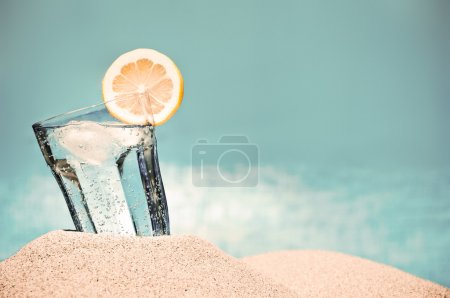 Cold drink on the beach on a hot summer day