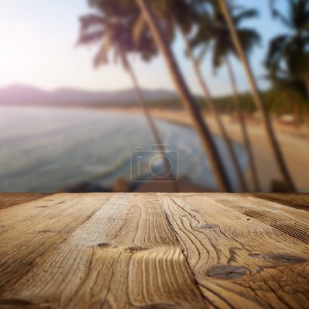 wooden table on the beach with palms