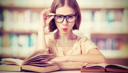 funny girl student with glasses reading books