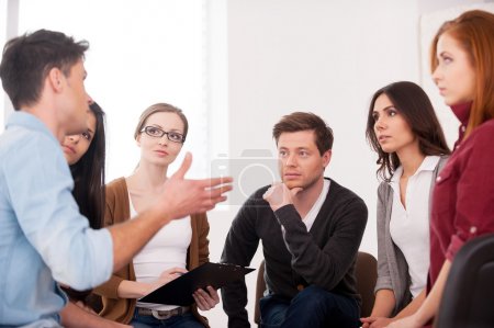 Man telling something for group of people