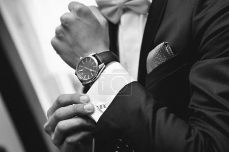 Man with suit and watch on hand