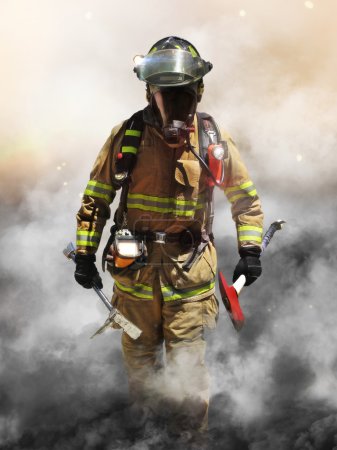 A firefighter pierces through a wall of smoke searching for survivors.