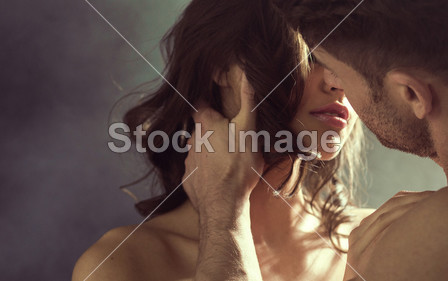 Sensual woman kissing her husband