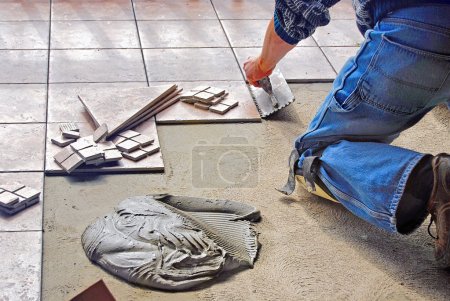 Man laying tile flooring