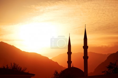 Mosque silhouette at sunset, with mountains on background, Turkey, Kemer