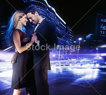 Handsome young couple dancing on the street and smiling