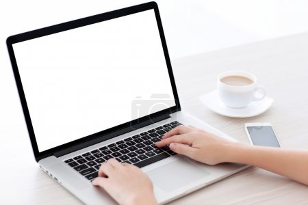 Female hands typing on a laptop keyboard with isolated screen in