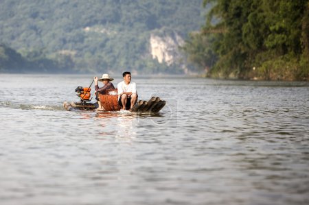 Two men on a bamboo boat on Li River near Guilin in China.