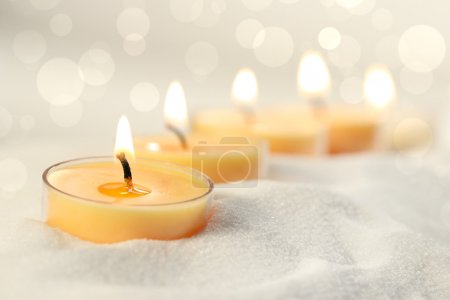 Votive candles in sand