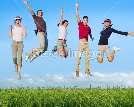 Jumping young happy group in meadow