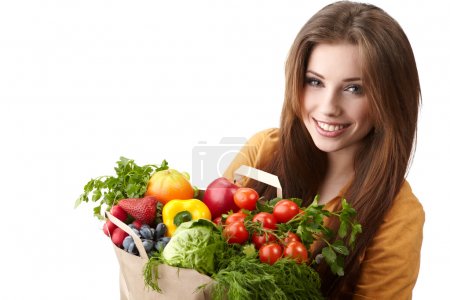 Woman holding a bag full of healthy food. shopping .