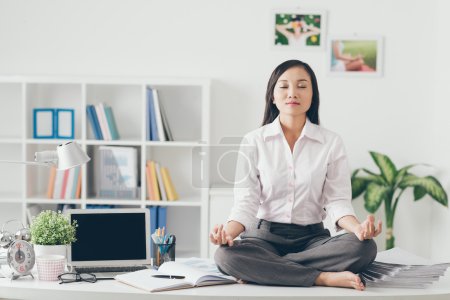 Female office worker meditating