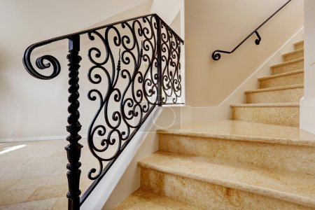 Marble staircase with black wrought iron railing