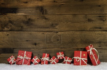 Wooden rustic background with red christmas presents.