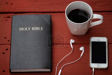 Bible with headphones and coffe