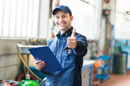 Worker in factory showing thumbs up