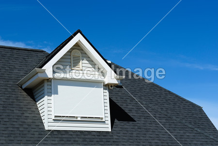 Attic window on the tiled roof