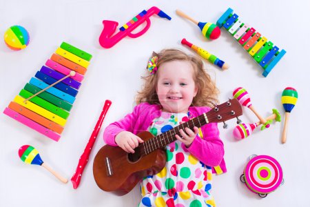 Little girl with music instruments