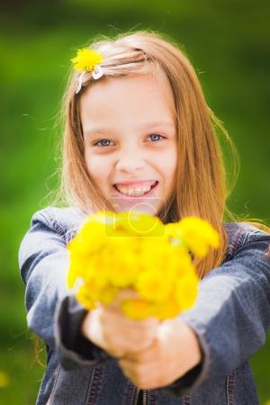 Portrait of smiling young girl holding bouquet of flowers