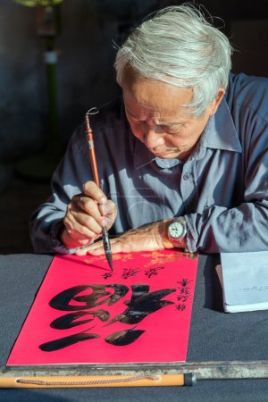 Calligrapher writing words on paper