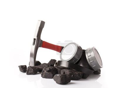 coal lumps  and protective ear muffs  isolated on a white background