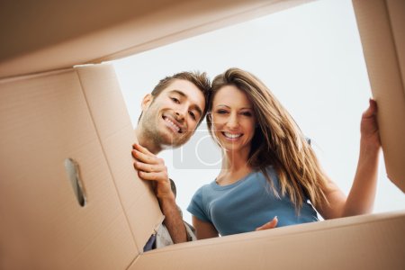 Happy couple opening a box