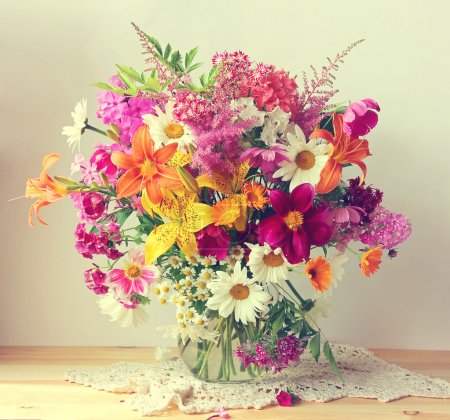 Bouquet from cultivated flowers in a jug.