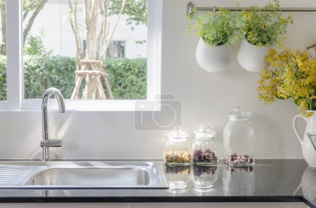 modern sink on black kitchen counter 