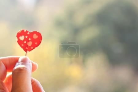 holding paper heart
