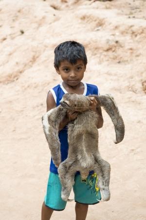 Boy holding sloth